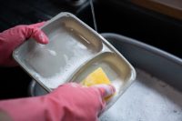 Customer washing up meal tray e1697636515133